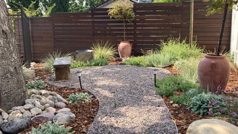 A secluded, peaceful corner featuring staked loropetalum 
