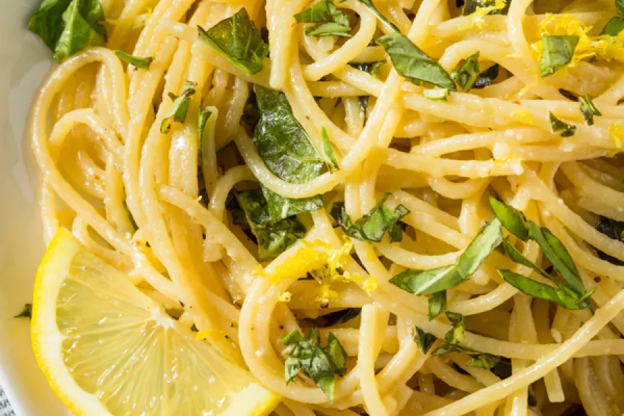 a white plate topped with lemon herb pasta
