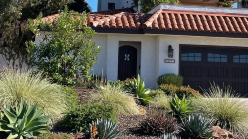 This beautiful, drought tolerant landscape is highlighted by an arbutus marina tree that beckons visitors as they approach the front entry. 